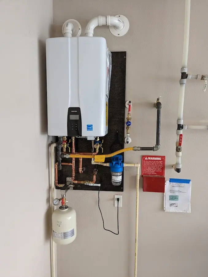 Professional plumber installing copper piping in a Greenwich home